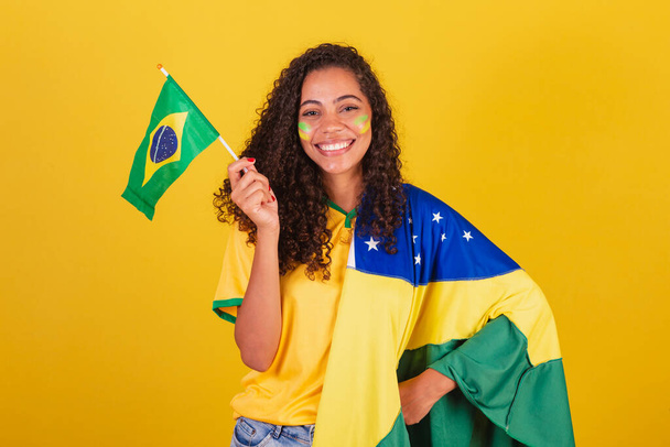 Young black Brazilian woman, soccer fan. waving flag, patriotic, nationalist. - Φωτογραφία, εικόνα