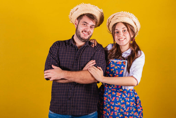 Beautiful couple wearing typical clothes for the Festa Junina. Arms crossed, confident. - Photo, Image