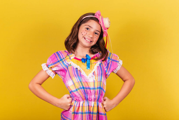 Brazilian, Caucasian child, party clothes, hands on waist, symbol of confident. May, June and July festivities, festa junina celebrations - Photo, image