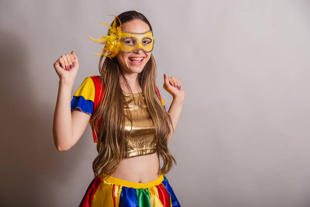 Beautiful Brazilian, Caucasian woman, wearing frevo, carnival clothes, wearing a mask. dancing. - Φωτογραφία, εικόνα