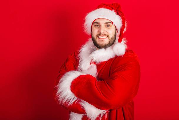 Caucasian, Brazilian man dressed in Christmas outfit, Santa Claus. crossed arms. - Foto, Bild
