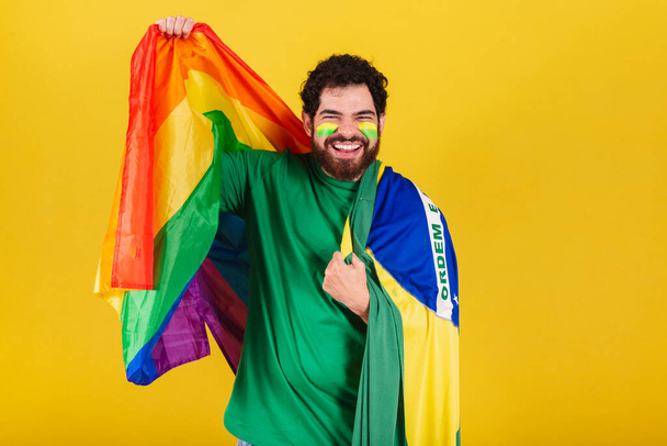 caucasian man with beard, brazilian, soccer fan from brazil, wearing lgbt flag - Фото, изображение