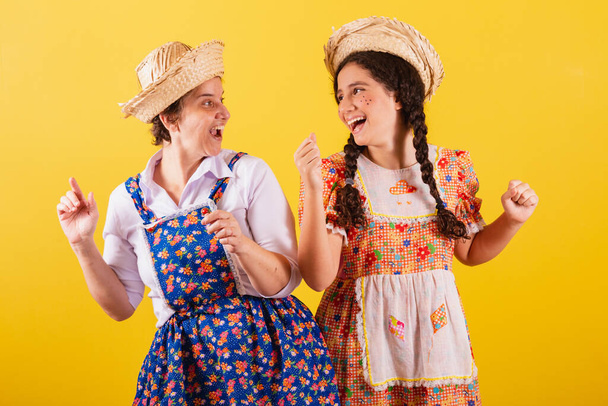grandmother and granddaughter dressed in typical Festa Junina clothes. Dancing, celebrating and partying. - Fotografie, Obrázek