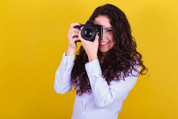 Caucasian woman, Brazilian photographer, holding photo camera, taking pictures. Advertising, audio visual. - Photo, Image