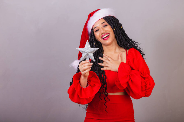 brazilian black woman wearing christmas clothes, merry christmas, smiling, holding star, christmas decoration - Zdjęcie, obraz