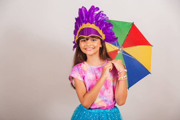 Beautiful Brazilian girl, child, dressed for carnival in Brazil. smiling with frevo umbrella. - Fotografie, Obrázek