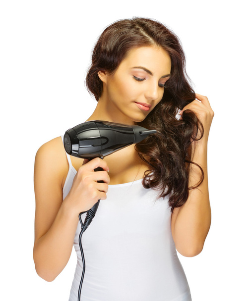 Young girl with hair dryer - 写真・画像