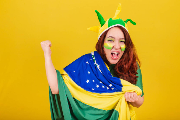 caucasian woman, redhead, soccer fan from Brazil, screaming goal! celebrating team victory in championship. - Photo, image