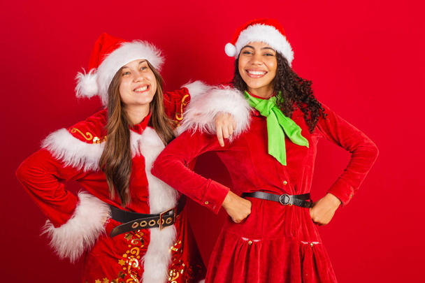 two brazilian friends, dressed in christmas clothes, santa claus. - Zdjęcie, obraz
