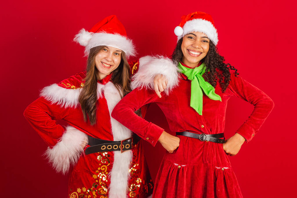two brazilian friends, dressed in christmas clothes, santa claus. - 写真・画像