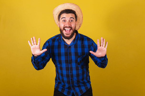 Man wearing typical clothes for Festa Junina. Expression of surprise, wow, amazing - Fotoğraf, Görsel