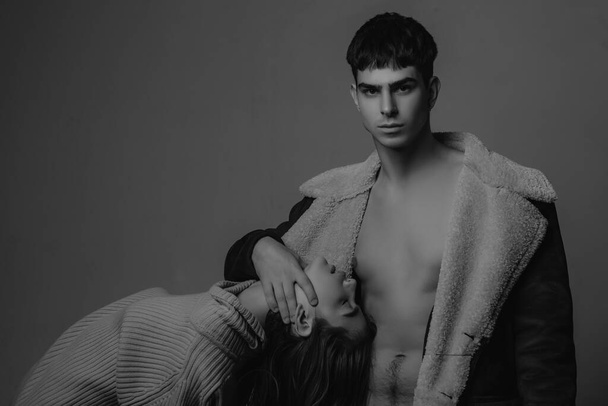 winter coat. fashion victim. couple in love. skincare and hair care concept. relationship in modern life. soft skin. lush hair. beauty and handsome. fashion couple on grey background, copy space. - 写真・画像