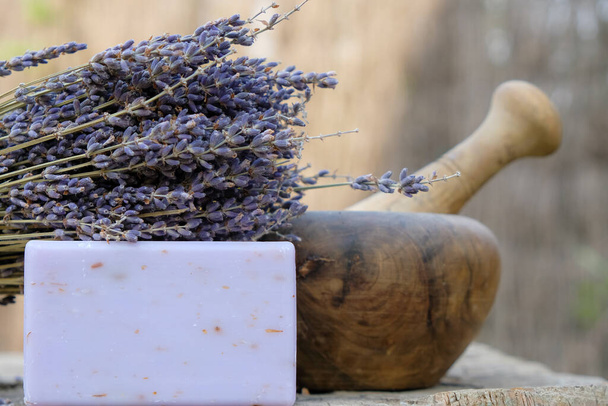 Lavender soap. Dry lavender. Wooden mortar and pestle. - Foto, Imagen