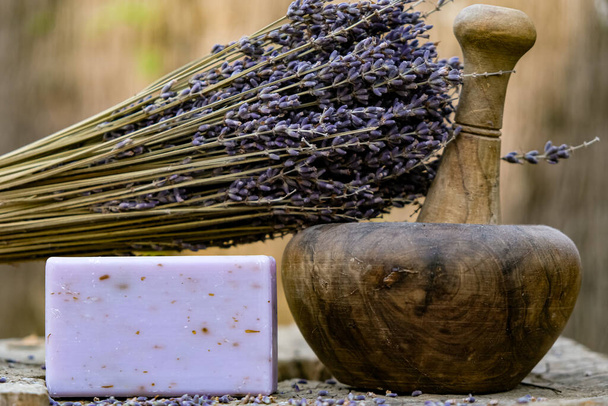 Lavender soap. Dry lavender. Wooden mortar and pestle. - Foto, afbeelding