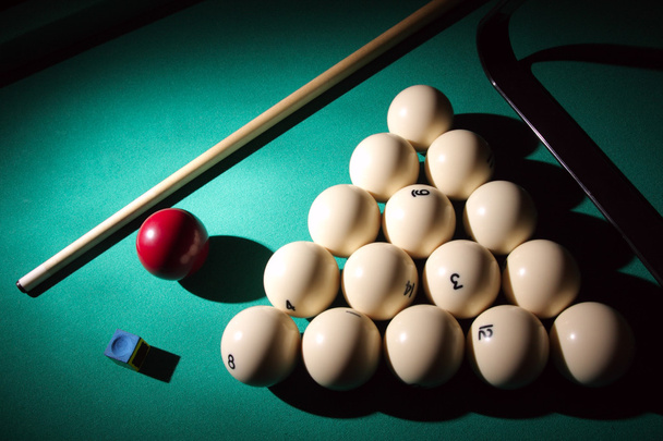 Billiard pyramid and cue on table. - Photo, Image
