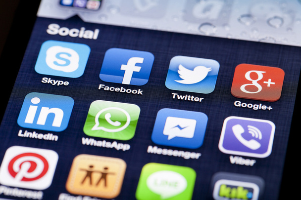 Close-up image of an iPhone screen with icons of social media apps - Fotoğraf, Görsel