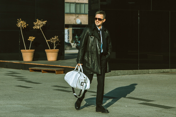 Beautiful fashion male model walking down the street - Foto, Imagen