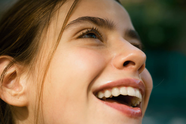 Laughing woman. Portrait of happy smiling girl. Cheerful young beautiful girl smiling laughing outdoor. Emotional face closeup - Foto, immagini