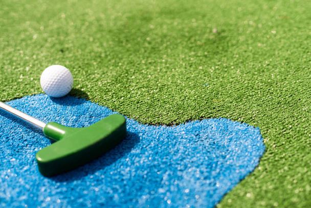 Golf sopa ve top yeşil çimenlerin üzerinde kapat - Fotoğraf, Görsel
