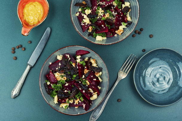 Tasty salad of beetroot, cheese, prunes and nuts - Photo, image