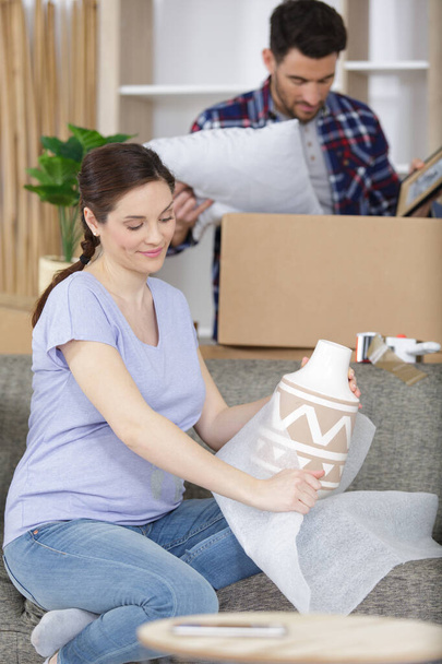 young family pregnant wife and husband with cardboard boxes - Photo, image