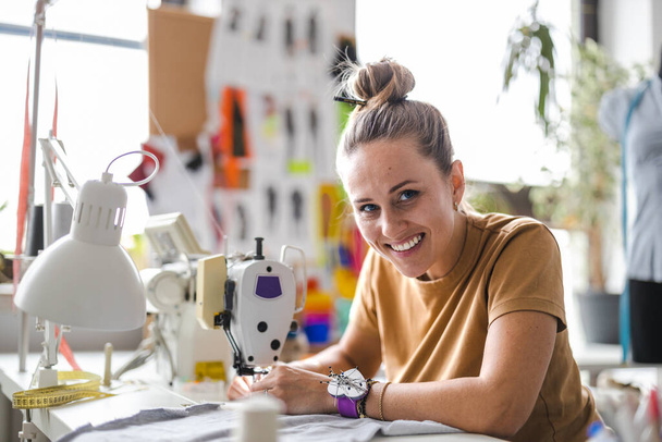 Young fashion designer working at her workplace - Foto, afbeelding