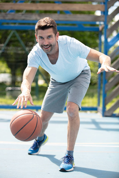 handsome male playing basketball outdoor - Fotoğraf, Görsel