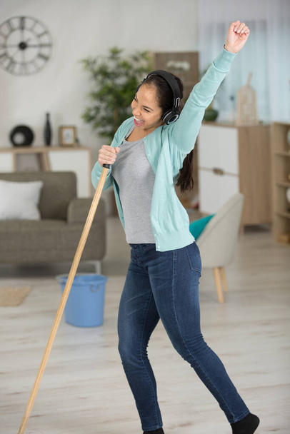 spring cleaning woman singing fun using mop - Φωτογραφία, εικόνα