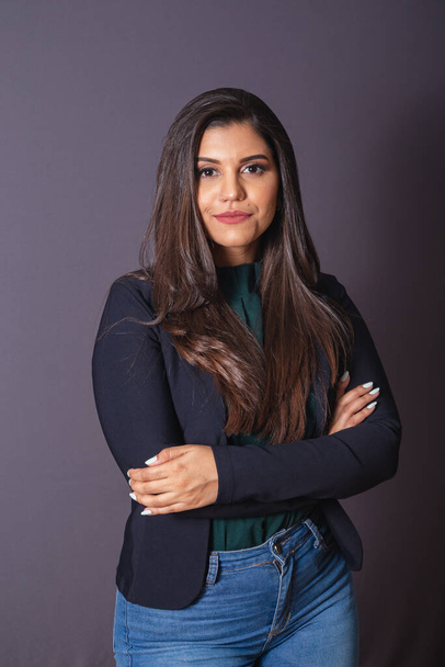 Horizontal photo. Beautiful Brazilian woman in casual clothes, black blazer jeans. Arms crossed. - Zdjęcie, obraz
