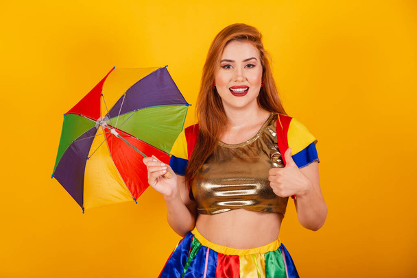Brazilian redhead, with carnival clothes, frevo, and colorful parasol. like, thumbs up, positive. - Fotó, kép