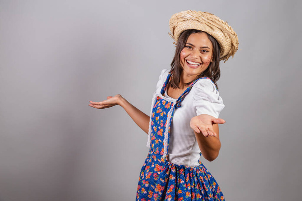 Brazilian woman wearing country clothes, So Joo party, Junina party. doubt or question.  - Zdjęcie, obraz
