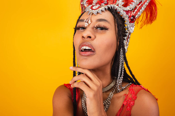 Beautiful black Brazilian woman, with red carnival clothes. close-up photo. - Foto, Imagem