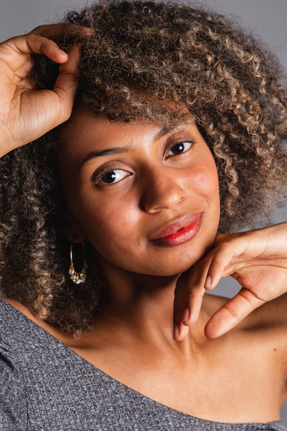 Beautiful black brazilian woman posing on grey studio background  - Fotografie, Obrázek