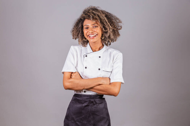 Young black Brazilian woman, cook, masterchef, wearing restaurant uniform. with arms crossed. - Photo, image