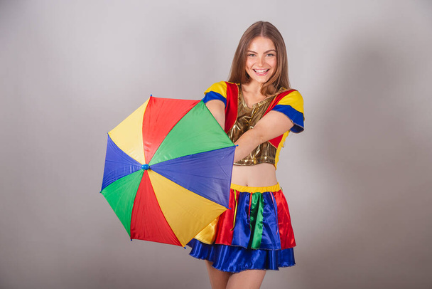 Brazilian blonde woman dressed in frevo clothes, carnival. with colorful frevo umbrella. dancing. - Foto, Imagem