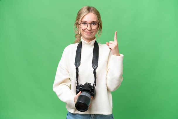Young photographer English woman over isolated background pointing with the index finger a great idea - Foto, immagini