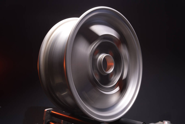 old car wheels titanium rims retro light alloy in a dark room long exposure photo - 写真・画像