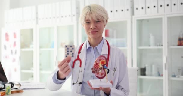 Arzt hält Tabletten und Nierenanatomie in der Hand. Konzept der Gesundheitsversorgung und frühzeitigen Behandlung von Nierenerkrankungen - Filmmaterial, Video