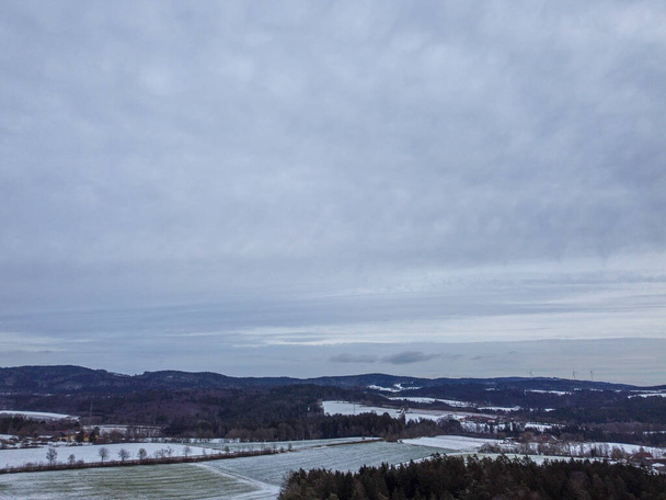 snow-covered agricultural fields in bavaria on a cloudy day - Foto, afbeelding