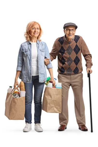 Daughter helping her elderly father and carrying grocery bags isolated on white background - Foto, afbeelding