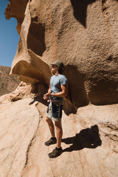 man standing in the rocky desert landscape of fuerteventura during a trek - Φωτογραφία, εικόνα