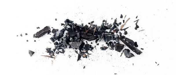 Black charcoal particles isolated on a white background, Activated charcoal powder - Foto, Imagen
