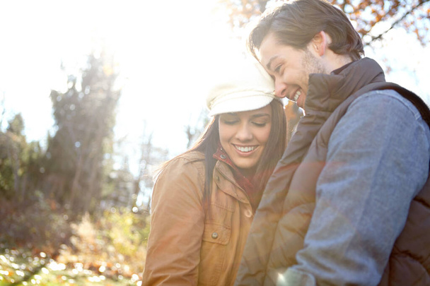 Feeling the love. A loving young couple standing together outdoors in the woods - Foto, imagen