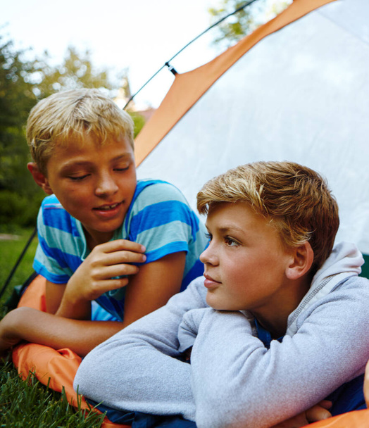 Camping rest and relaxation. three young boys lying in their tent - Photo, Image