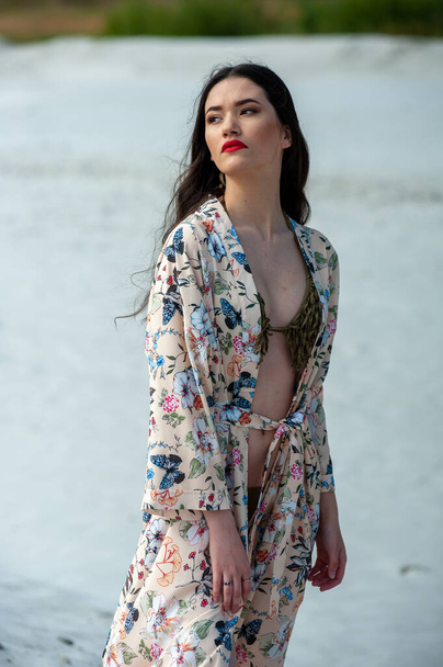 beautiful young woman in a white dress on the beach - Zdjęcie, obraz