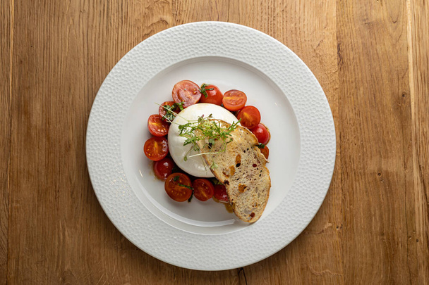 delicious buratta cheese on a white plate - Fotografie, Obrázek