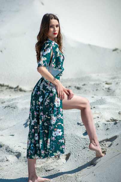 beautiful girl in a dress with a bag on the beach - Фото, зображення