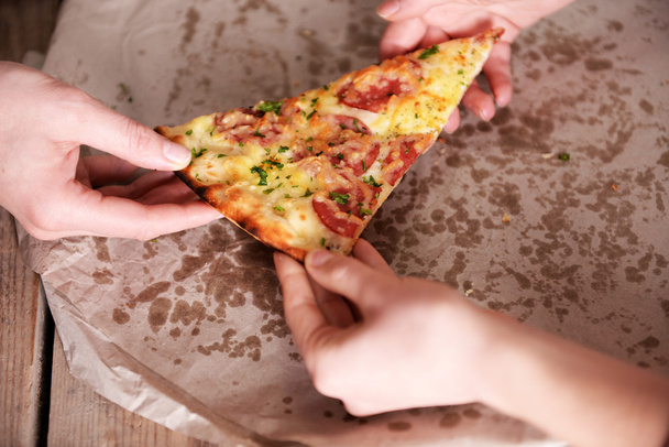 Friends hands taking slice of pizza - Φωτογραφία, εικόνα