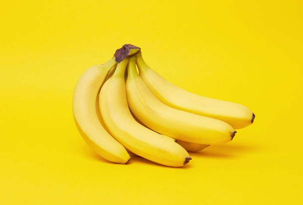 Bananas on a yellow background - Photo, Image