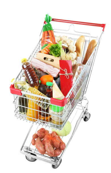 Shopping cart full with various groceries isolated on white  - Foto, Bild